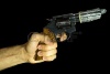 2211744-male-hand-holding-a-revolver-with-a-condom-on-it-black-background.jpg